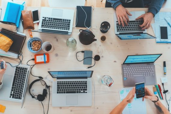 bird's eye view of 5 team memvers working on their computers