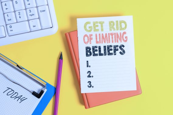 Writing note showing Get Rid Of Limiting Beliefs. Business concept for remove negative beliefs and think positively Pile of empty papers with copy space on the table
